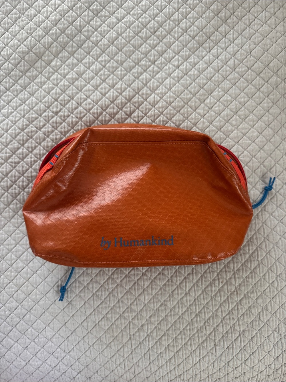 Humankind Orange Zip Travel Pouch with Blue Logo